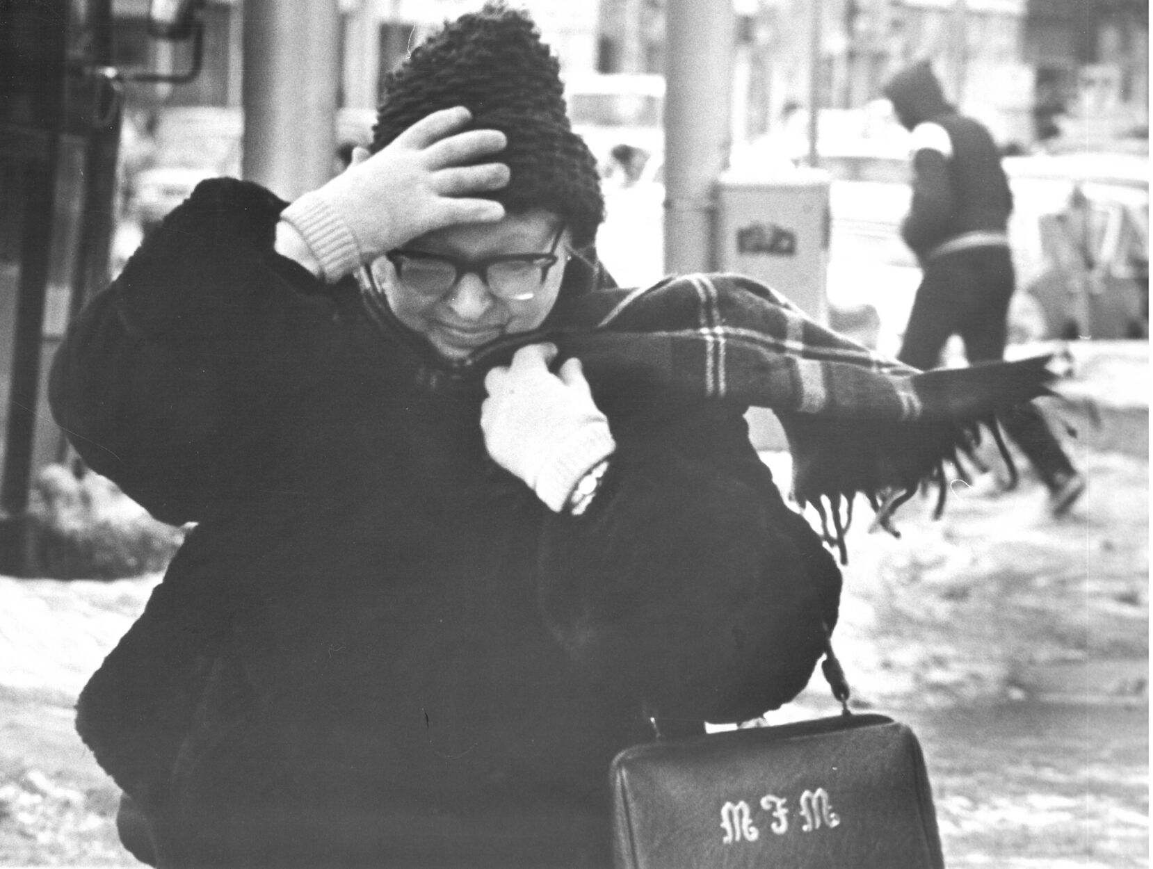 Woman holds on to her hat